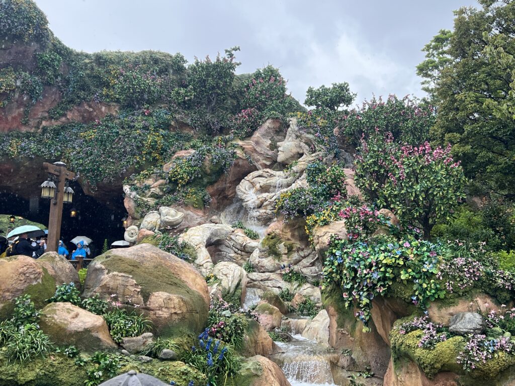 Lush greenery and a beautiful artificial waterfall at Fantasy Springs in Tokyo DisneySea