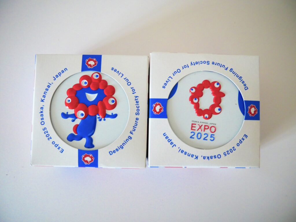 White souvenir tin featuring Expo 2025 Osaka official mascot Myaku-Myaku and logo by Kobe Fugetsudo.