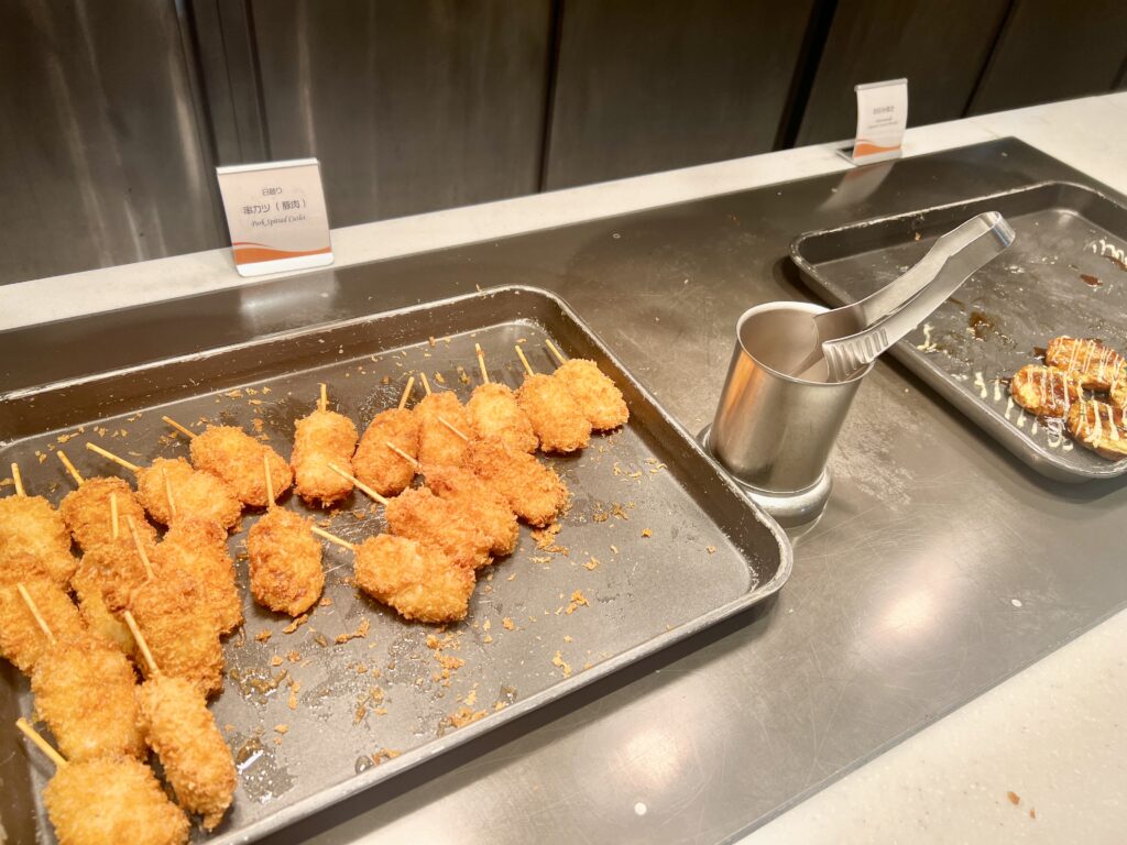Crispy kushikatsu skewers lined up on a tray at the hotel’s breakfast buffet.