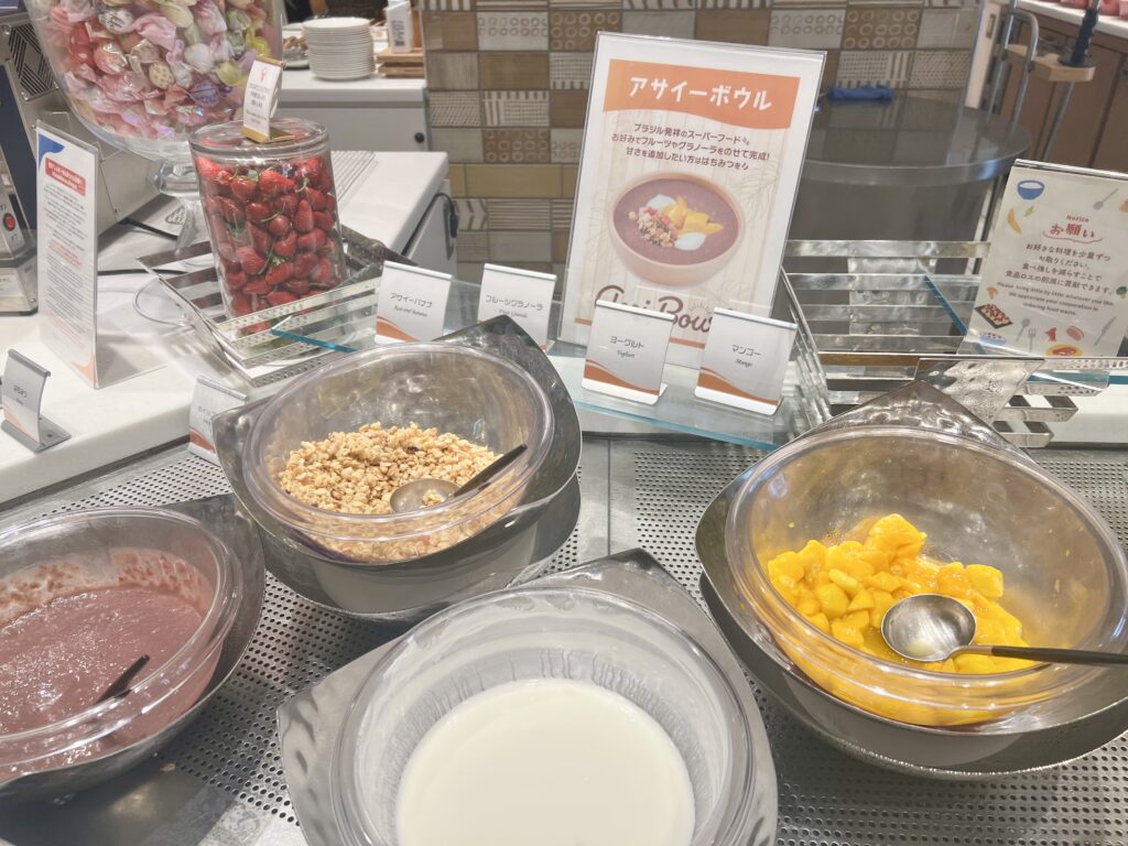 Acai bowl ingredients including granola, yogurt, and mango at the Universal Port Vita breakfast buffet.