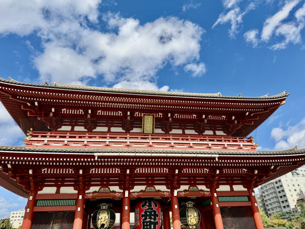 The main hall of Senso-ji Temple in Asakusa, Tokyo, captured on a sunny day with bright blue skies.