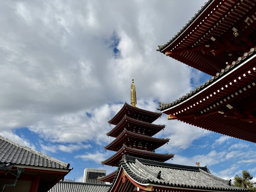 The five-story pagoda at Senso-ji Temple in Asakusa, Tokyo, standing tall against the cloudy sky.